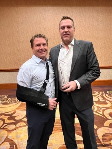 Spencer Burt, Sales Manager for Futura Transitions received manufacturer of the year award from Jeff Brugman, Executive Director of the Powerhold group.