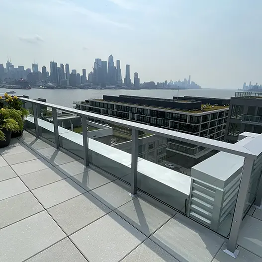 Balcony view of a city skyline across a river.